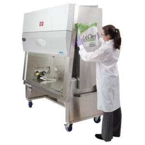 lab personnel adding animal feed to a nuaire animal handling biosafety cabinet